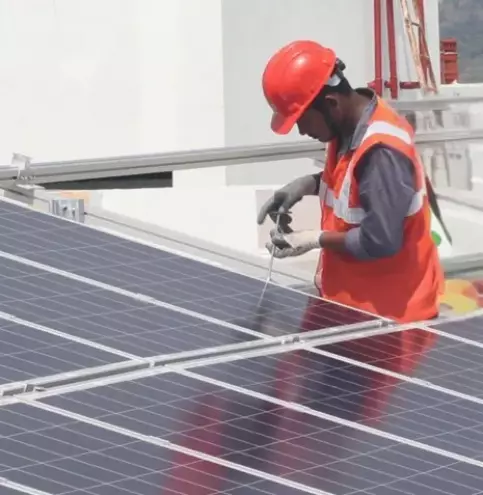 Worker installing solar panels